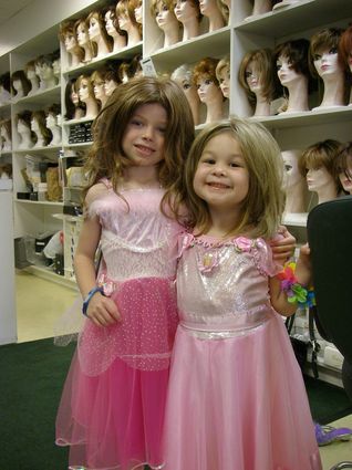 Abella and her friend Katelyn trying on wigs